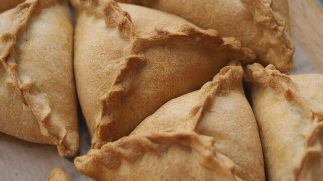 Uchpuchmak - national dish of Tatar and Bashkir cuisine. Delicious flour pastries with meat and triangular potatoes. Turkic culture. Top view