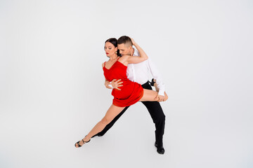 Full size photo of two young passionate dancing partners performing isolated on white color background