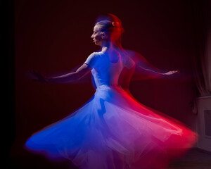 Fototapeta premium Caucasian woman dancing classical dance in tutu . Long exposure photo. 