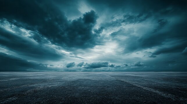 A dramatic nighttime horizon with a dark concrete floor, framed by an expansive sky filled with striking clouds, evoking a cinematic atmosphere
