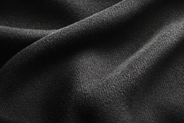 Fototapeta premium Soft, dark fabric drapes gracefully, creating an abstract composition of folds and shadows