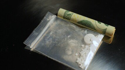 Focus on white crystalline powder made of crushed oxycodone prescription medications pills and...