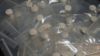 Seized by police, Oxy, Meth, Fentanyl or synthetic opioid drugs. Powder drugs pressed in pills shape and packaged in to small plastic bags for transportation and sale in clubs, party and streets.