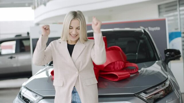 Woman celebrates her new car purchase in spacious showroom