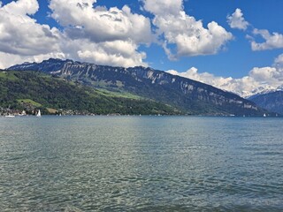 A lake in the Swiss Alps. The Blue Lake in Switzerland. Snow-capped mountains near the lake. Spring.