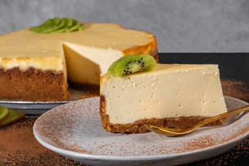 Delicious cheesecake with cottage cheese on the table, decorated with kiwi.