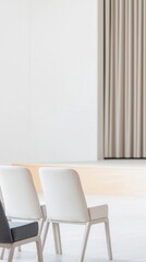 Minimalist interior with modern chairs and soft curtains.