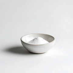 Small White Ceramic Bowl with Bicarbonate on Minimalist White Background