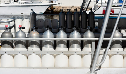 Many Scuba tanks lines up on a commercial dive boat in Key Largo, Florida, USA. 