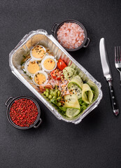 Healthy breakfast consisting of boiled eggs, slices of ham, tomatoes, green beans, aioli sauce