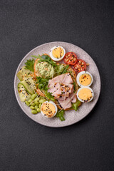 Healthy breakfast consisting of boiled eggs, slices of ham, tomatoes, green beans, aioli sauce