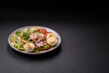 Healthy breakfast consisting of boiled eggs, slices of ham, tomatoes, green beans, aioli sauce