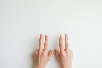 Two hands showing two fingers each on a white background