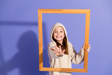 Cheerful Young Girl Framed Against Purple Background Posing Enthusiastically