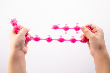 Hand squeeze pink stress ball on white background. Positive thinking concept. Copy space