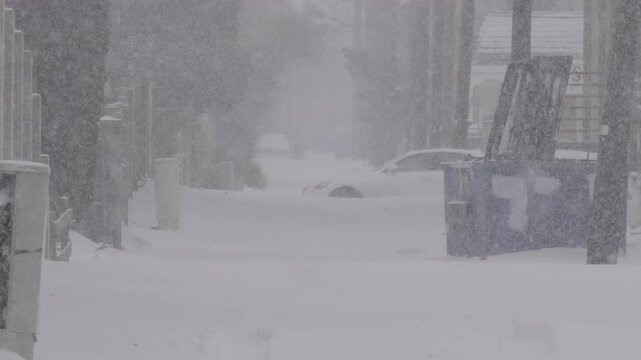 Slow Motion Snow Storm in an Alley with Car Driving By
