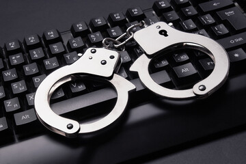 Handcuffs on keyboard background