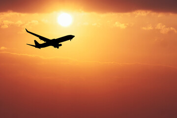 Sunset Flight: A majestic airplane silhouette ascends against a vibrant, fiery sunset, its journey symbolizing adventure, travel, and the limitless possibilities of the open sky. 