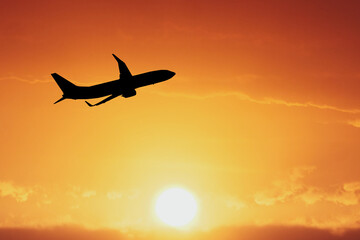 Airplane Taking Off at Sunset: A silhouette of an airplane ascends against a fiery orange sunset, symbolizing the start of a journey, adventure, and new horizons.