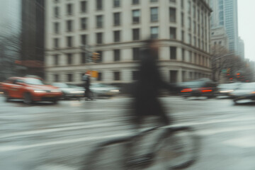 Fototapeta premium A blurry image of a city street with a person riding a bicycle
