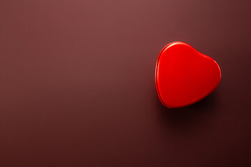 Red heart isolated on brown background