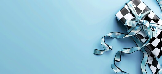 Black and white checkered Christmas gift with decorative ribbon on blue surface