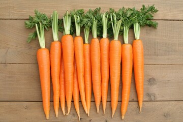 Freshly picked carrots lying on a wooden table promoting healthy eating and sustainable agriculture