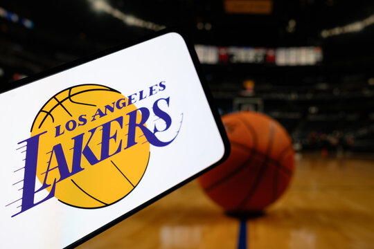 London, UK, 01.30.2025: Los Angeles Lakers basketball team logo on phone screen with basketball arena background