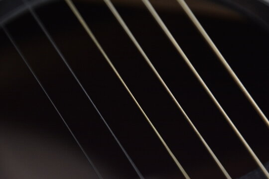 Black guitar with strings from close up