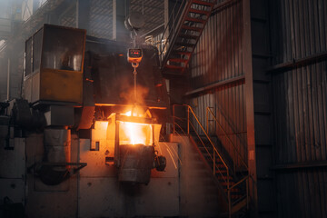 Molten metal is poured from a furnace in a metalworks factory
