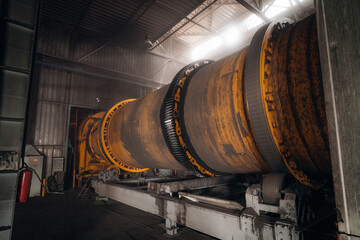 Industrial rotary kiln in a processing plant Large cylindrical machine for industrial processes