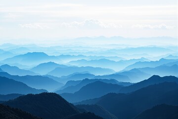 Fototapeta premium Serene blue mountain ranges under a bright sky.
