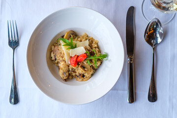 Creamy mushroom risotto delicately garnished with parmesan and cherry tomatoes