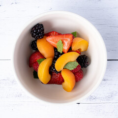 Fruit salad on a white wooden table