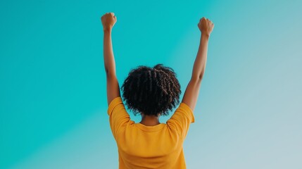 A young person celebrating with raised arms against a vibrant blue background, embodying freedom, joy, and a positive attitude. Perfect for themes of empowerment and happiness.