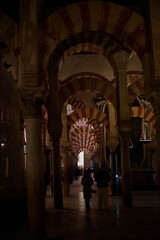 The interior of the Mosque-Cathedral of Córdoba, featuring its iconic columns and horseshoe arches, a masterpiece of Moorish and Spanish architecture in Andalusia, Spain