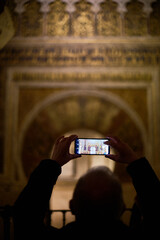 The mihrab of the Mosque-Cathedral of Córdoba, an exquisite example of Moorish artistry, featuring intricate arabesques and golden mosaics in Andalusia, Spain