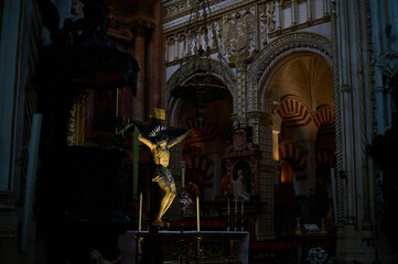 The interior of the Mosque-Cathedral of Córdoba, featuring its iconic columns and horseshoe arches, a masterpiece of Moorish and Spanish architecture in Andalusia, Spain
