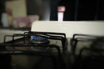 Stove burner lit where the flame is visible.