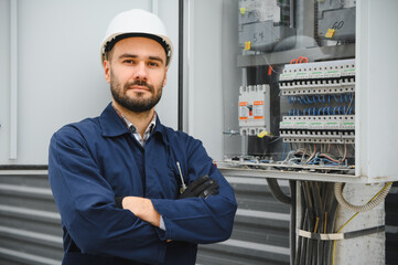Electrical engineer approving power distribution box installation on site