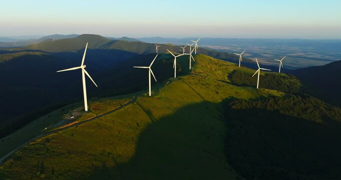 Wind Turbines Installed On Mountain Ridge Vibrant Sunset Aerial Steady Shot