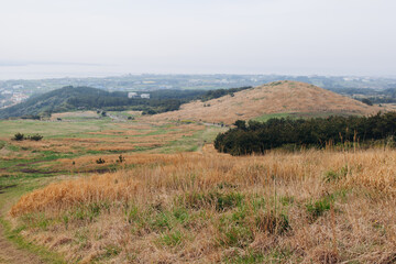 Naklejka premium Udo Island, Jeju Island province, South Korea, Jeju-do, panoramic aerial view of coastline sea landscape in a sunny day, U-do Island, Soseom cow island, Jeju-si