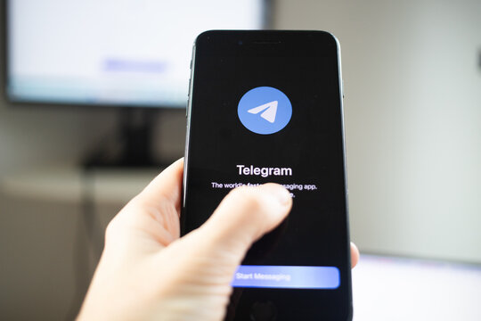 person opening Telegram app on a phone