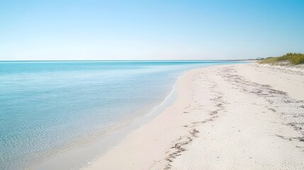 Obraz premium Serene Beach Landscape, Clear Water, White Sand, and Blue Sky