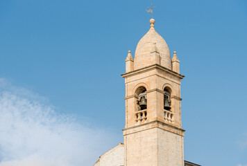 The bell tower of the Santa Lucia Church in the ancient village of Alberobello, Puglia, Italy