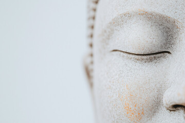 Tranquility in Stone: A close-up view of a serene Buddha statue's closed eye, symbolizing peace, mindfulness, and the pursuit of inner harmony.
