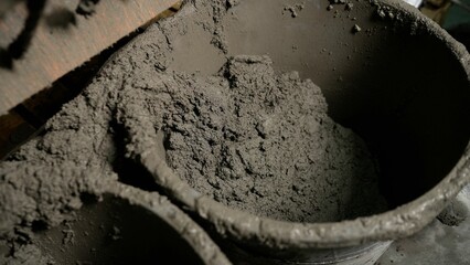 Buckets overflowing with freshly mixed cement at construction site