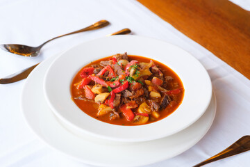 Hearty stew with meat peppers and mushrooms
