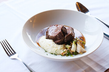 A delectable dish featuring slow cooked meat creamy mashed potatoes and roasted vegetables