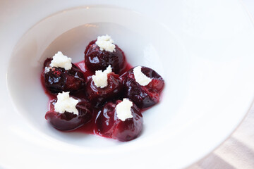 Sweet and savory plums gently simmered until tender topped with a dollop of creamy cheese